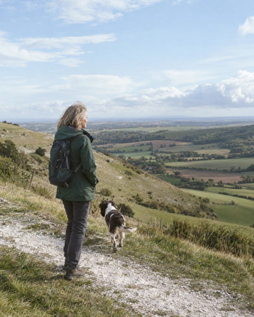 A business owner takes a quiet weekday dog walk along a chalk path in the South Downs.
